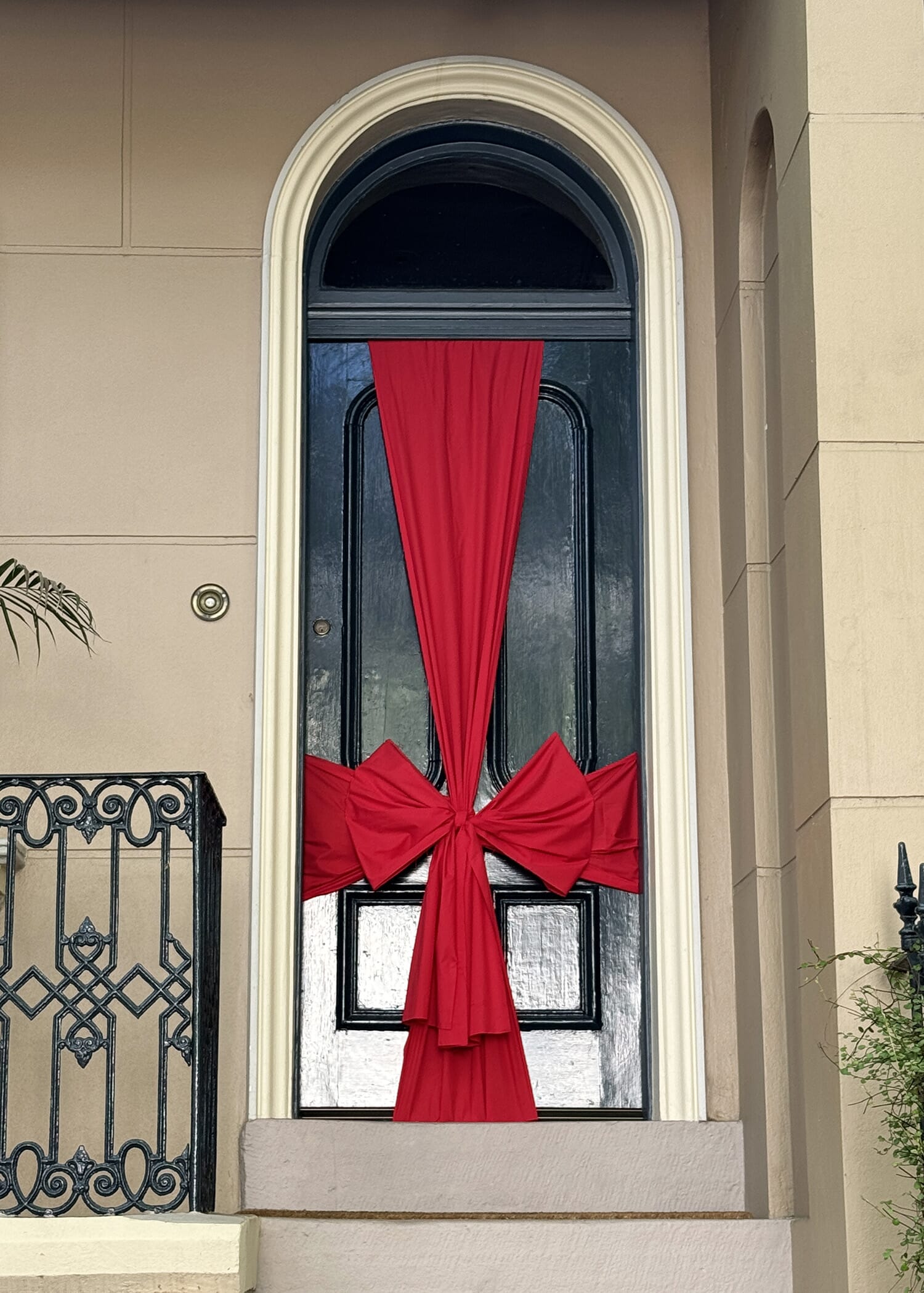 Pictured: A big red bow on a door at Bourke Street Surry Hills