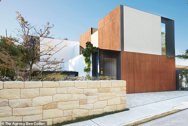 The contemporary home features cement, wood and sandstone finishes.