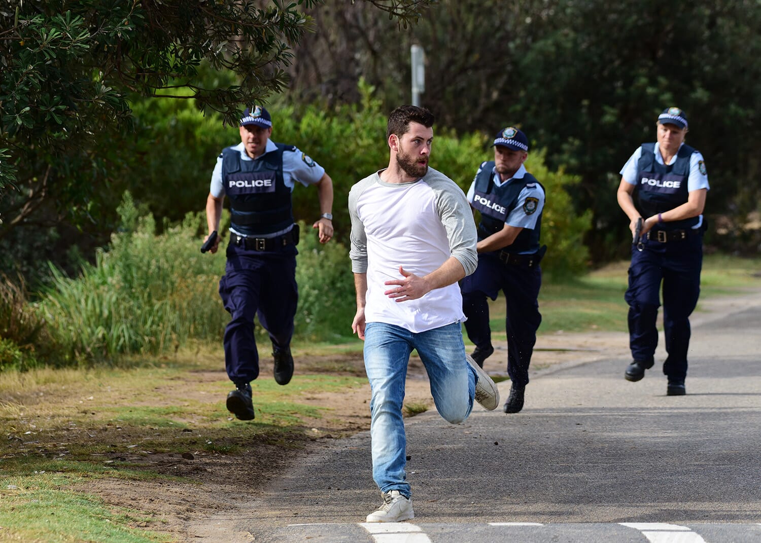 Police officers chase a man