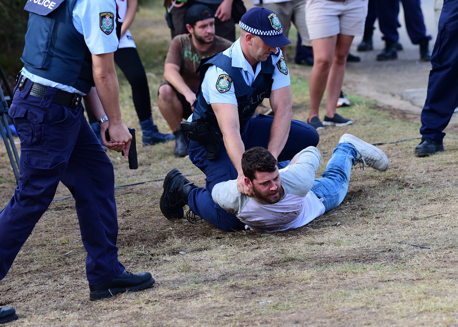 Police officers arrest a man