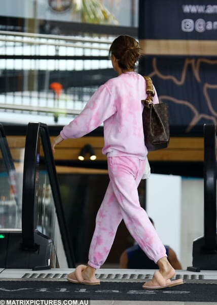 KC Osborne treats herself while dressed in a pink tracksuit