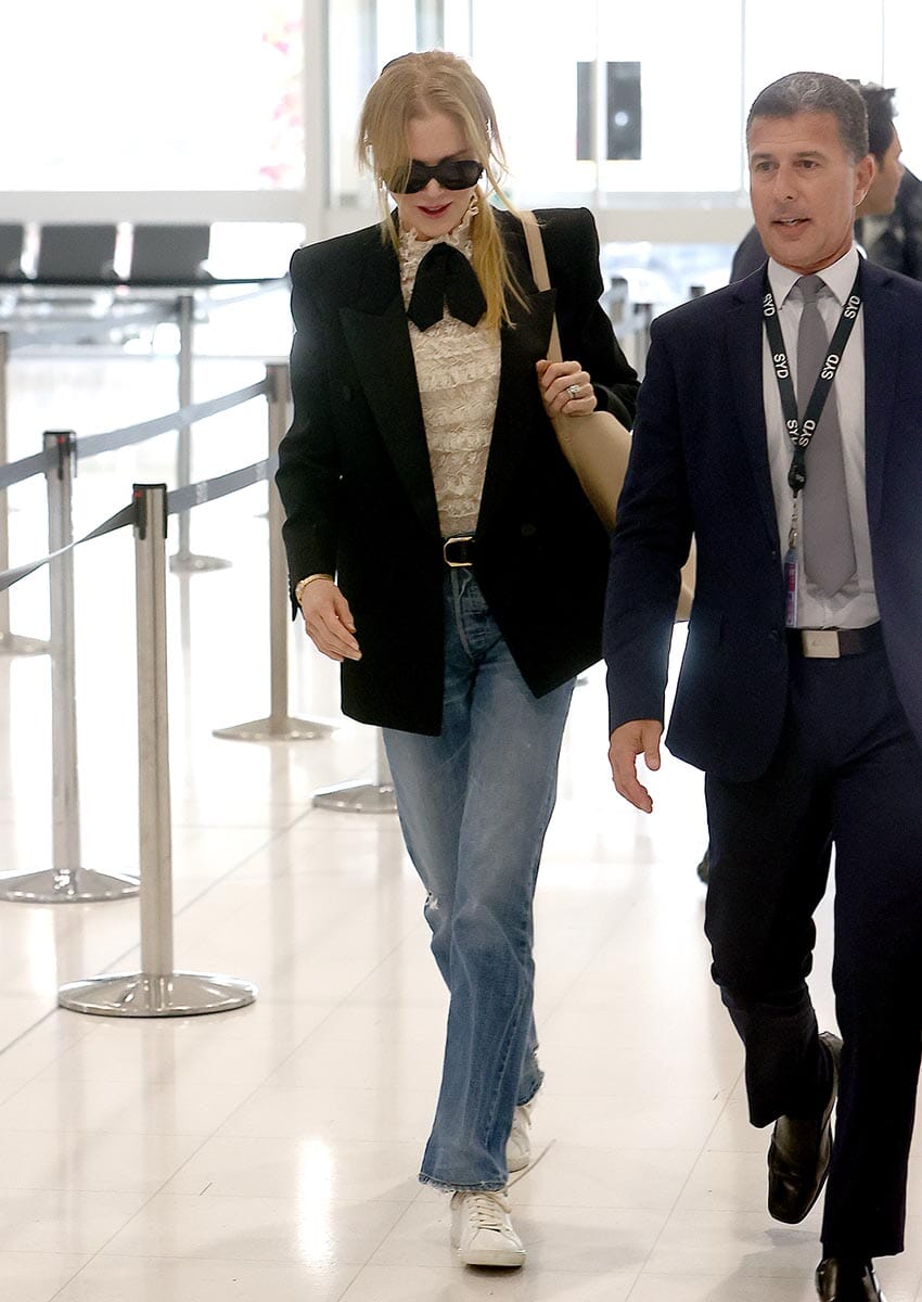 PICTURED: NICOLE KIDMAN IS ESCORTED PAST ANNOYING FANS BY AIRPORT VIP FLUFFER