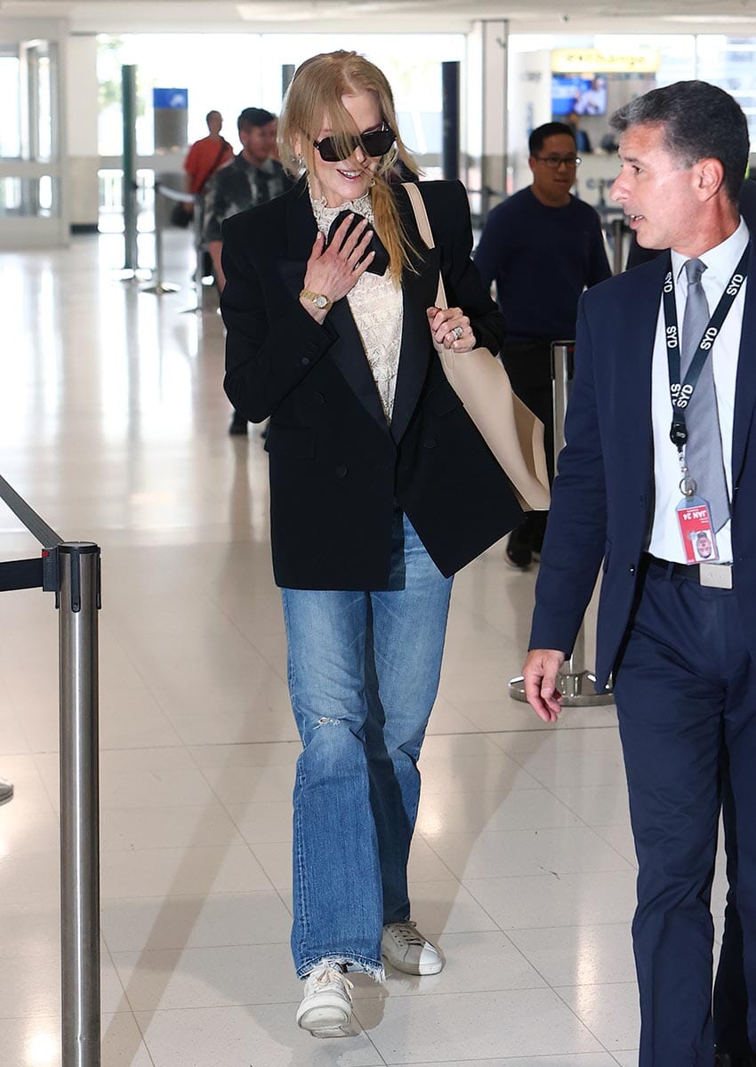 PICTURED: NICOLE KIDMAN IS ESCORTED PAST ANNOYING FANS BY AIRPORT VIP FLUFFER