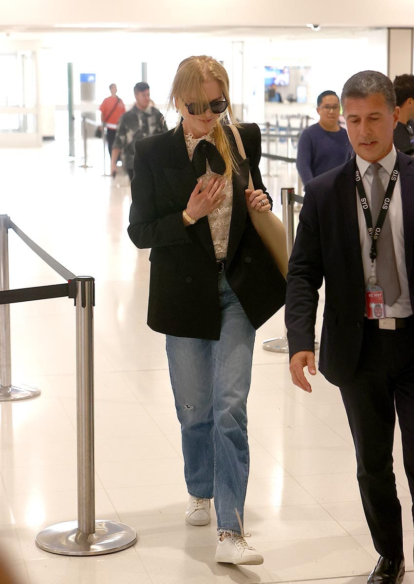 PICTURED: NICOLE KIDMAN IS ESCORTED PAST ANNOYING FANS BY AIRPORT VIP FLUFFER
