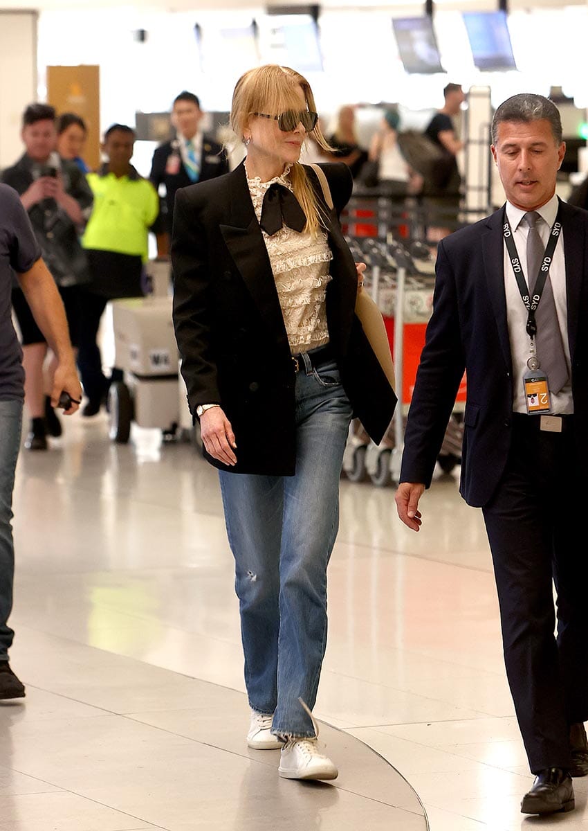 PICTURED: NICOLE KIDMAN IS ESCORTED PAST ANNOYING FANS BY AIRPORT VIP FLUFFER