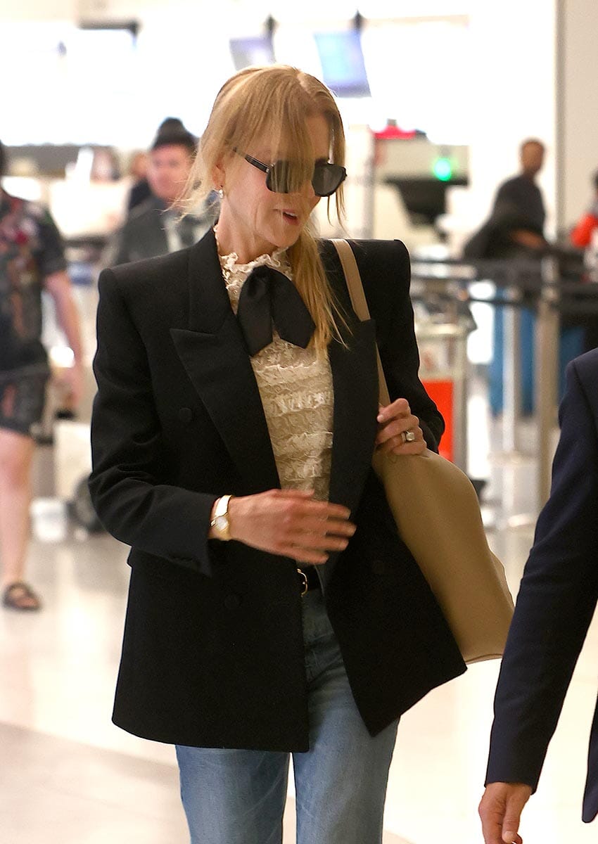 PICTURED: NICOLE KIDMAN IS ESCORTED PAST ANNOYING FANS BY AIRPORT VIP FLUFFER
