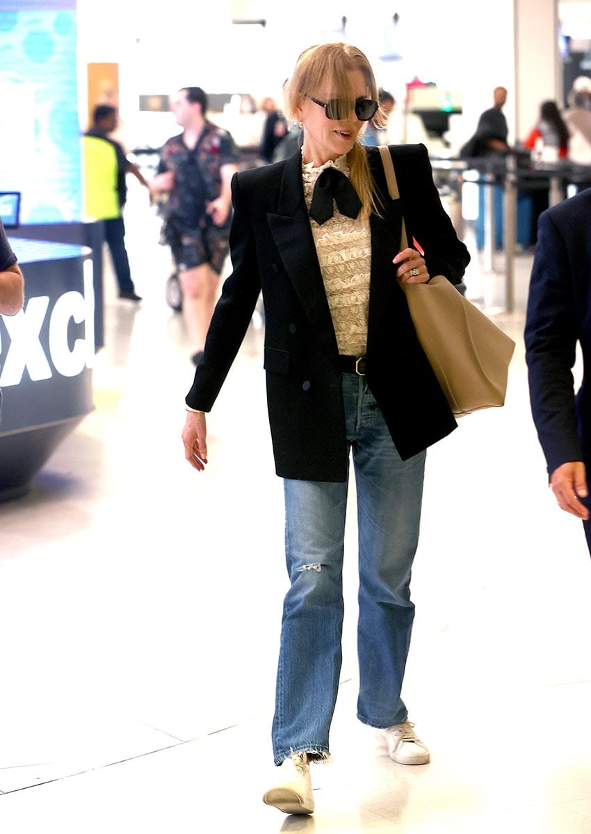 PICTURED: NICOLE KIDMAN IS ESCORTED PAST ANNOYING FANS BY AIRPORT VIP FLUFFER